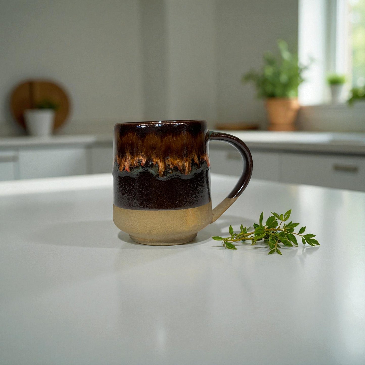 Brown ceramic mug on a white countertop with greenery in the background