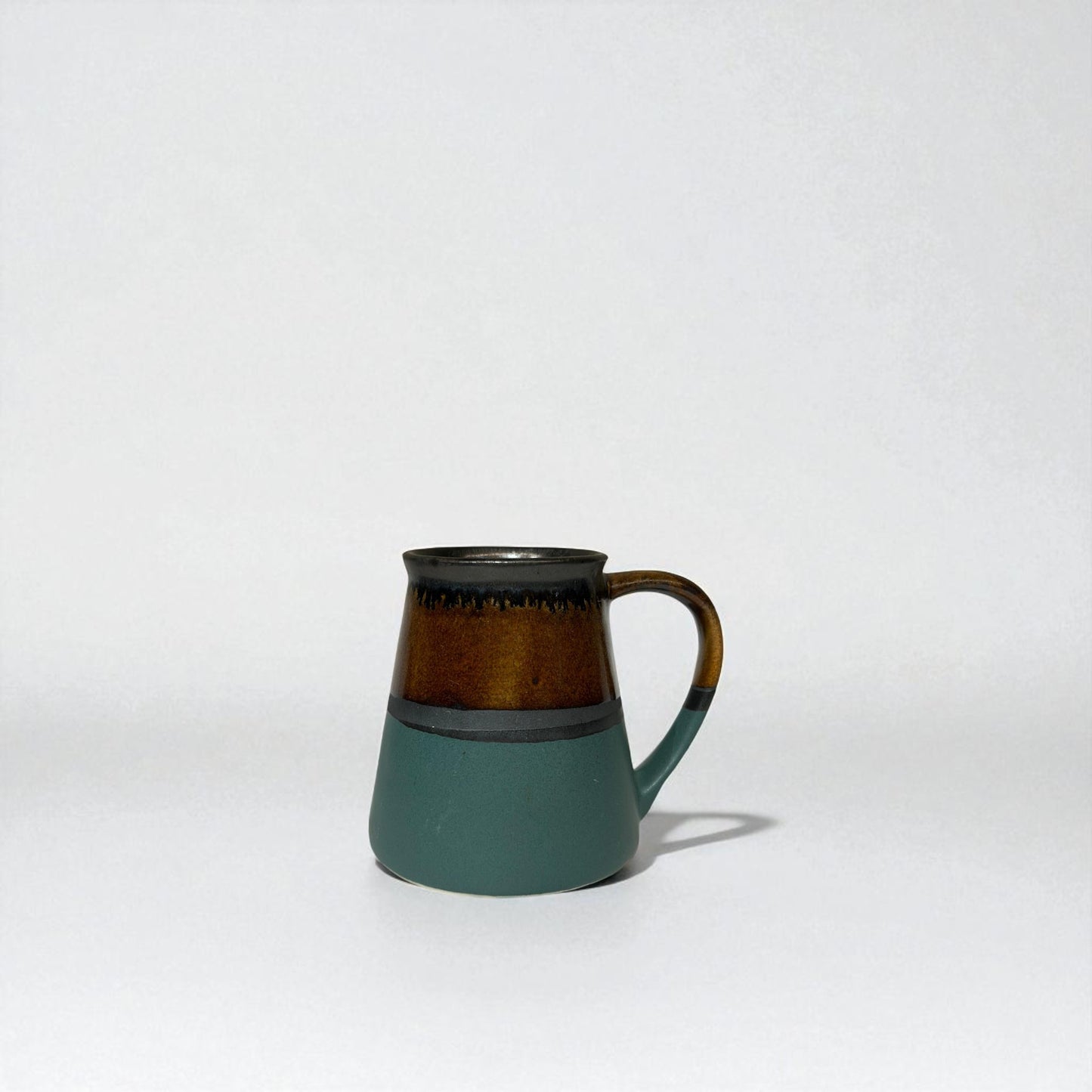 Ceramic mug with a two-tone design on a white background