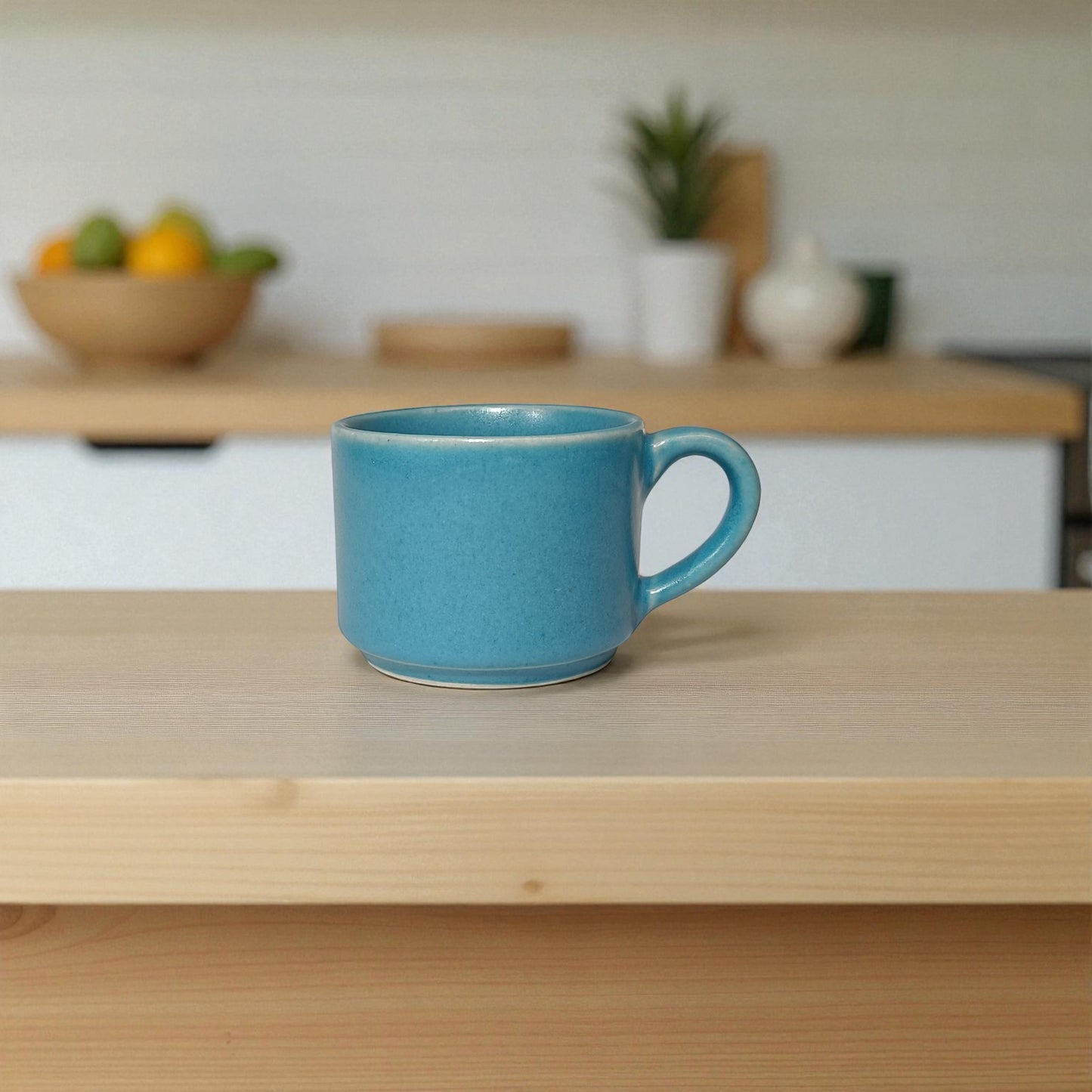 Blue mug on a wooden surface with a blurred kitchen background