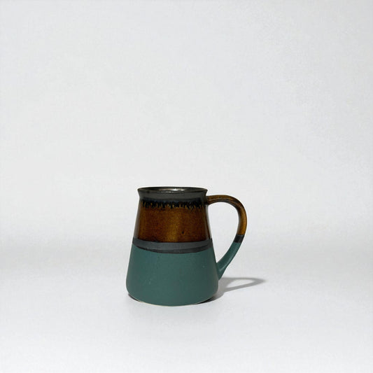 Ceramic mug with a two-tone design on a white background