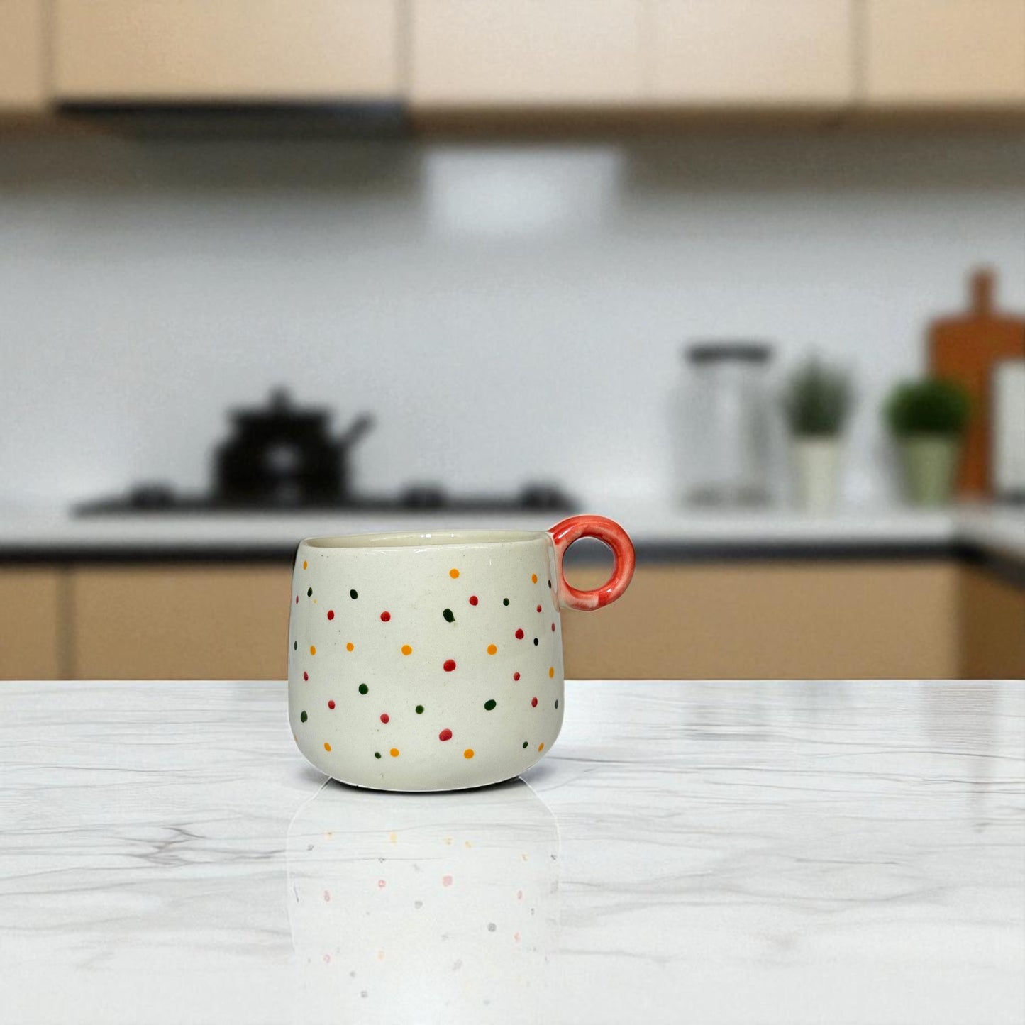 Polka dot mug with a red handle on a kitchen counter